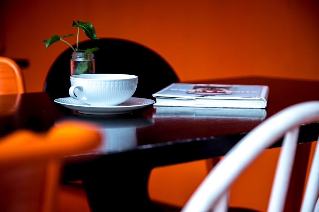 Stylish table setting with coffee and magazines in a bright cafe