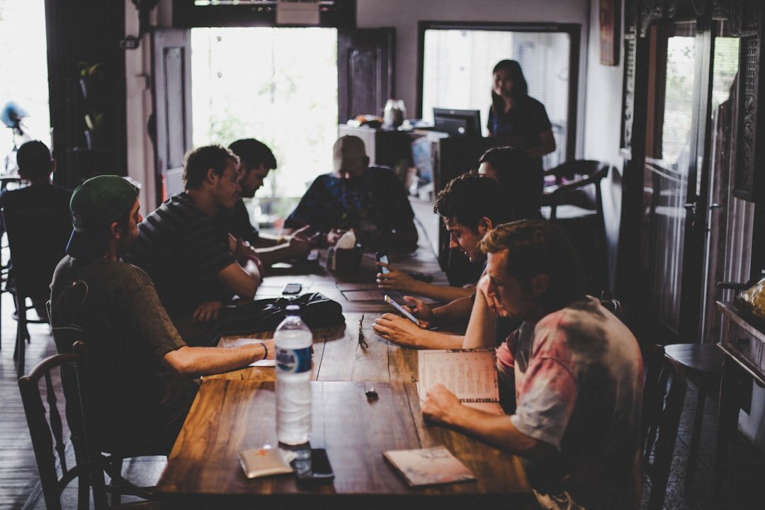 Small editorial team having a meeting around a table