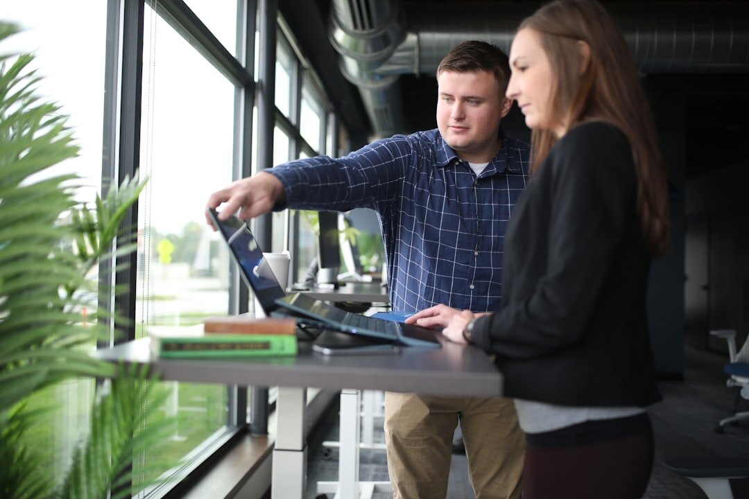Two colleagues reviewing documents at a desk