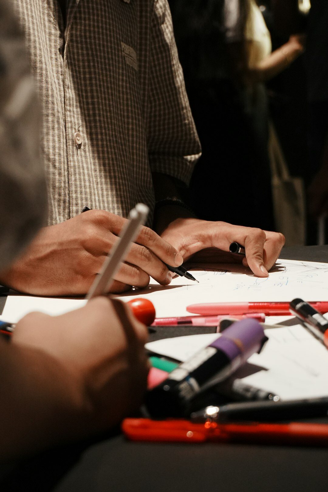 Close up of hands writing notes with a pen