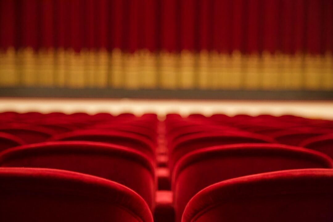 Cinema theater with empty red seats and screen